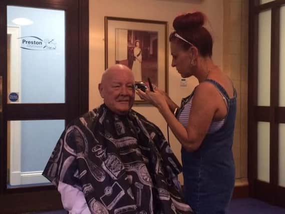 Coun Rollo having his head shaved to help the parents of baby Lil who has cancer