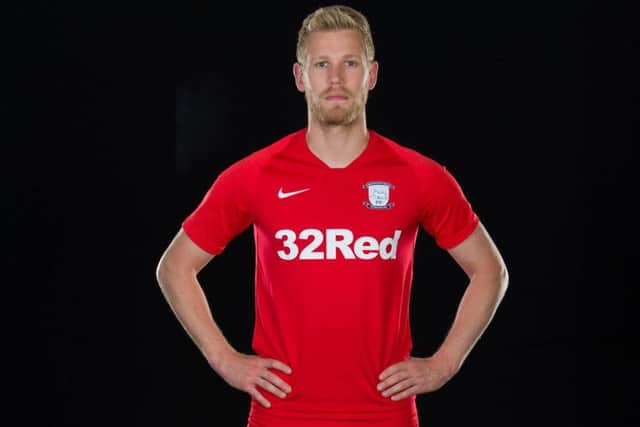 Preston striker Jayden Stockley models the red away kit which has now been ditched