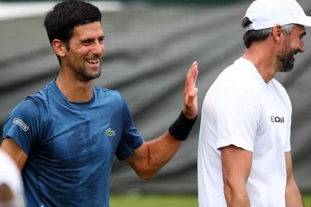 Novak Djokovic of Serbia speaks with Goran Ivanisevic during a practice session (Photo by Clive Brunskill/Getty Images)