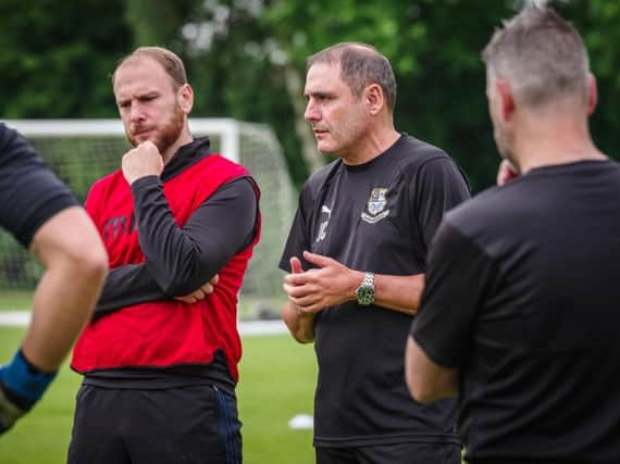 Bamber Bridge manager Joey Collins (right) with coach and skipper Matt Lawlor in the red bib Picture: Ruth Hornby