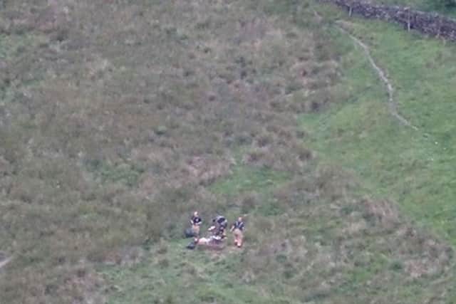 Firefighters with a barbeque that was being used on Saddleworth Moor