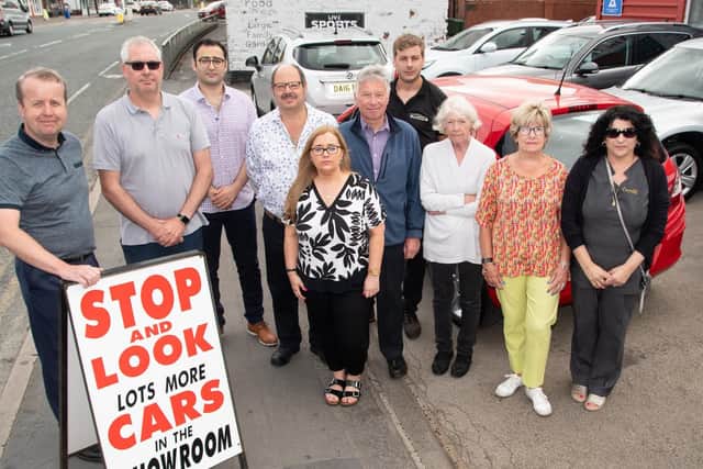 Some of the town's shop owners and workers gather to show the strength of feeling against the slip road closure