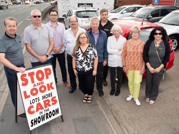 Some of the town's shop owners and workers gather to show the strength of feeling against the slip road closure