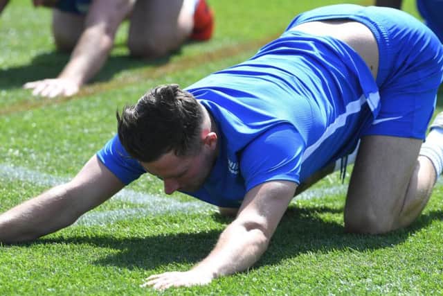Preston midfielder Alan Browne stretching in pre-season training