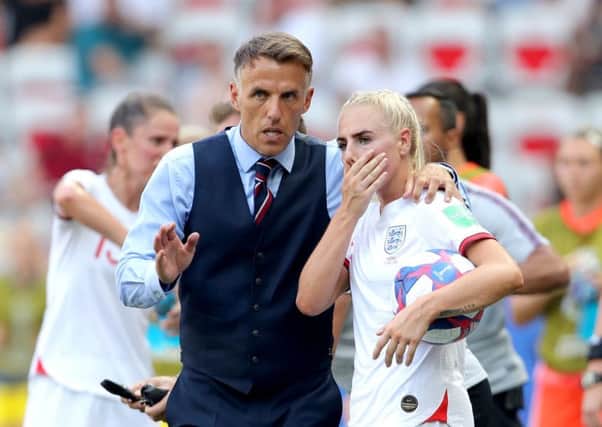 Head coach Phil Neville talks tactics with Alex Greenwood during the Women's World Cup third-place play-off