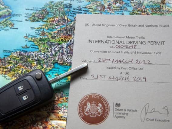 An International Driving Permit issued by the Post Office
