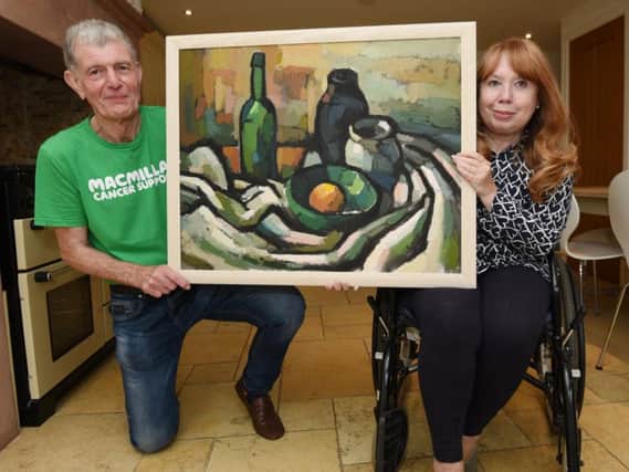 Christine Pilkington pictured with husband David, left, and the Wilfred Andrews painting which is to be sold for Macmillan