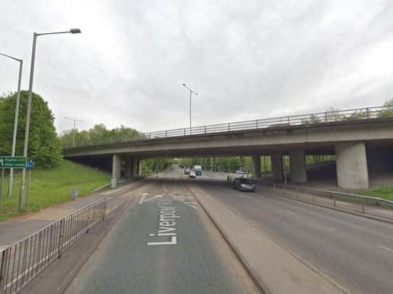 A 26-year-old woman has been arrested after she came off the bridge above Liverpool Road and landed on a stationary lorry this morning (July 19)