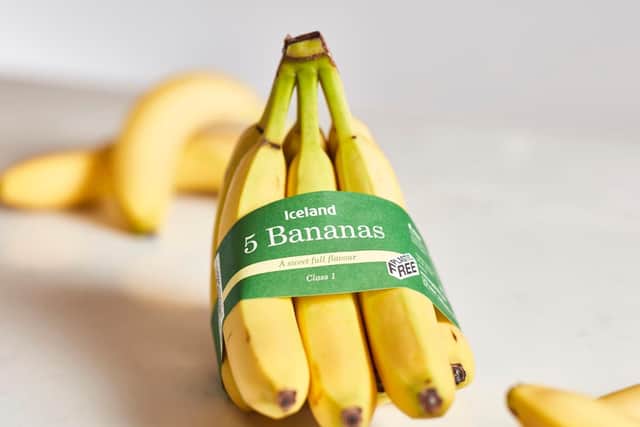 Pre-packaged bananas which are being sold in a recycled paper band