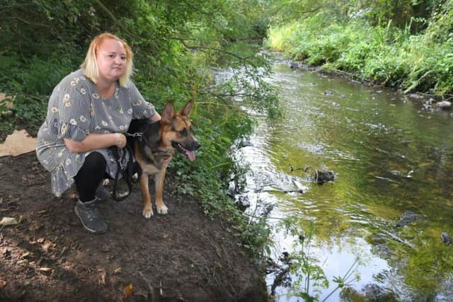 Kerry Moran, with her dog Ghost, found oil pollution in the River Lostock near Mill Lane, Farington Moss