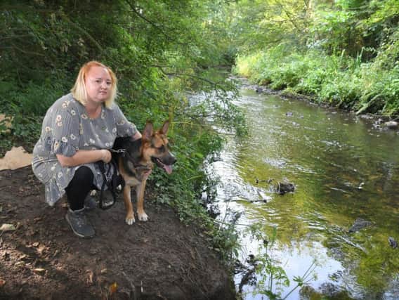 Kerry Moran, with her dog Ghost, found oil pollution in the River Lostock near Mill Lane, Farington Moss