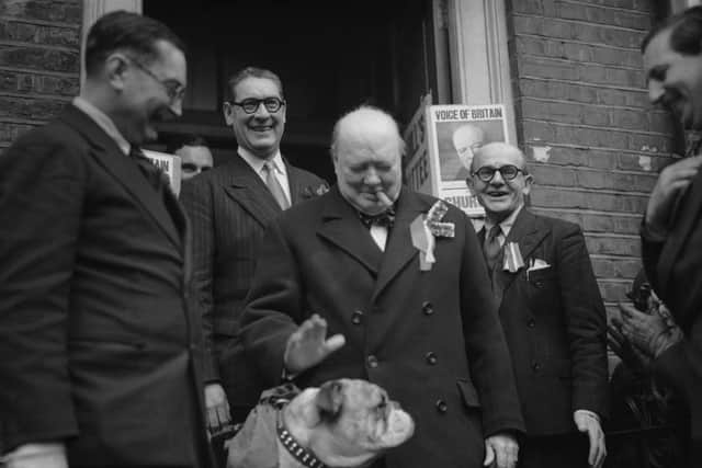 British Conservative Party leader Winston Churchill with a bulldog mascot on General Election day, 23rd February1950