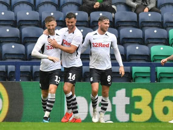 Paul Gallagher is congratulated by Andrew Hughes and Alan Browne after scoring Preston's second penalty against Newcastle