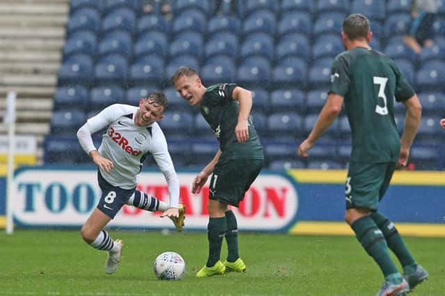 Preston midfielder Alan Browne goes to ground under a challenge from Matt Ritchie