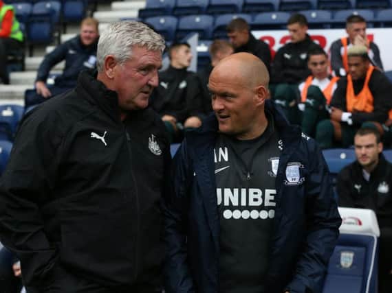 Newcastle boss Steve Bruce and Preston manager Alex Neil have a chat on the touchline at Deepdale