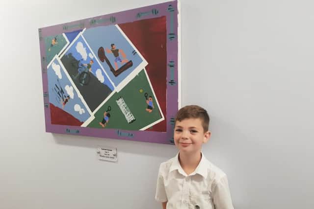 Samuel Goode from Woodlea Junior School with a piece of artwork hes designed for Leyland Surgery