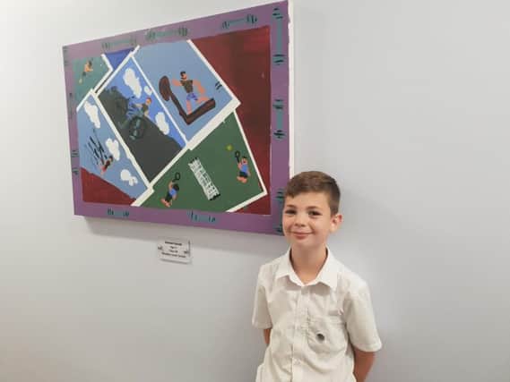 Samuel Goode from Woodlea Junior School with a piece of artwork hes designed for Leyland Surgery
