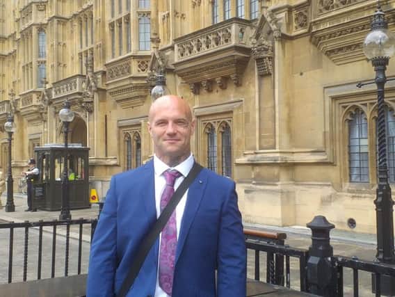 Alex Fishwick outside the Houses of Parliament