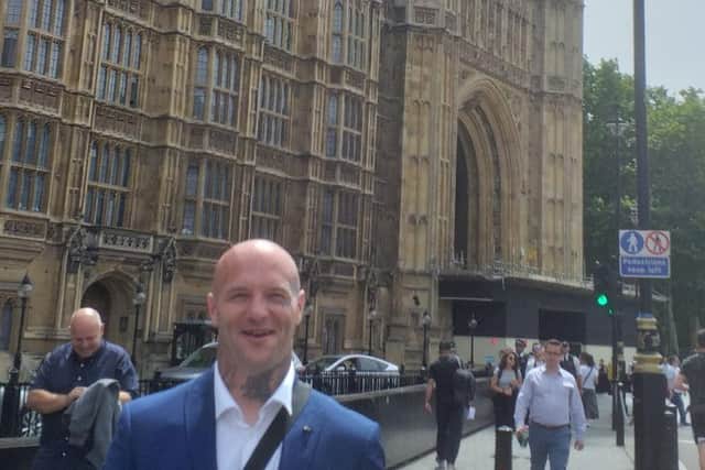 Alex Fishwick outside the Houses of Parliament