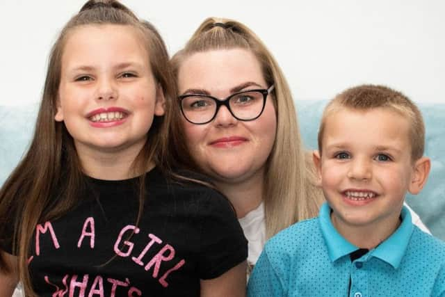 'Superhero' Jaxon Youd with his mum Carly Grant and sister Josie Youd. Photo: Kelvin Stuttard