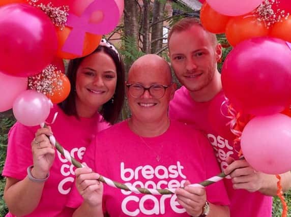 Vicki Lea with her twins Adam and Jessica, who raised 3,020 for Breast Cancer Care by holding an afternoon tea party