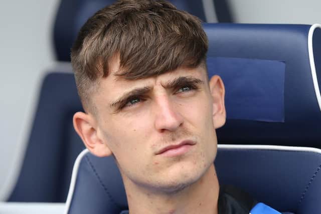 Preston North End's new signing Tom Bayliss in the dugout at The Den after not being included in the match day squad against Millwall