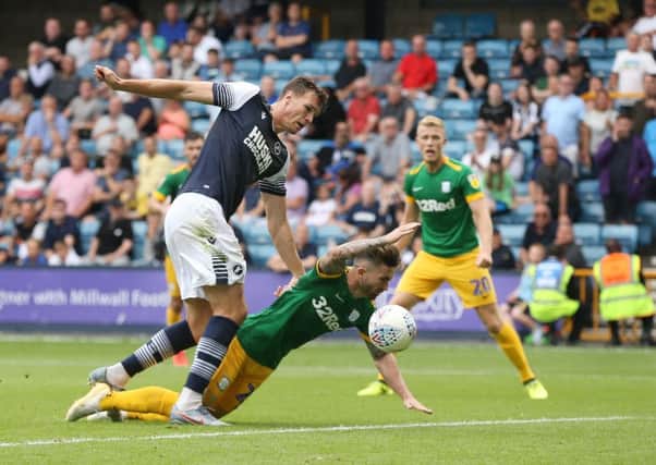 Sean Maguire goes down under pressure from Millwall's Jake Cooper but no penalty was awarded
