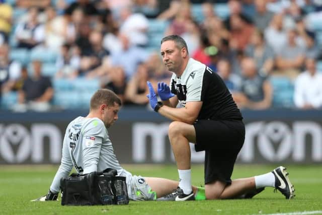 The Millwall physio signals that goalkeeper Frank Fielding cannot continue against Preston