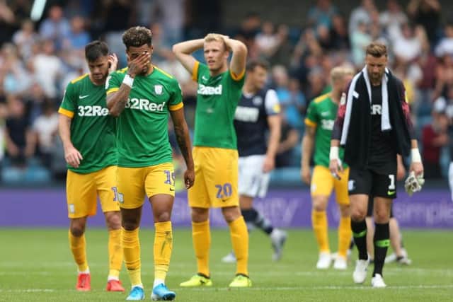 The Preston players show their disappointment at the final whistle at The Den