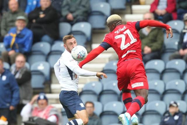 Preston striker Louis Moult challenges Wigan's Cedric Kipre