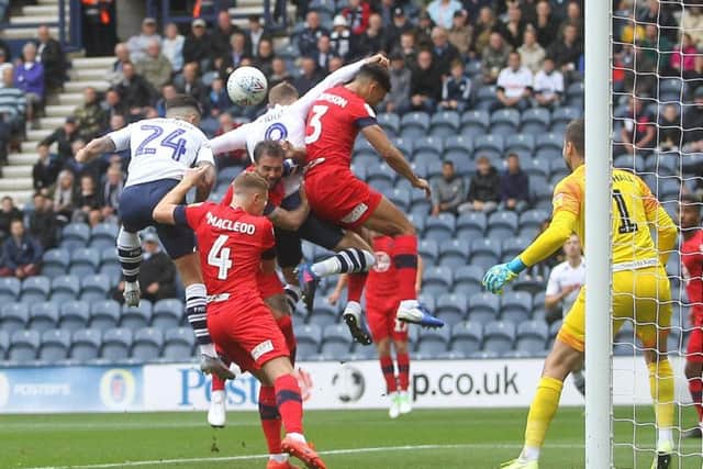 Sean Maguire gets with Louis Moult to score Preston's opening goal against Wigan