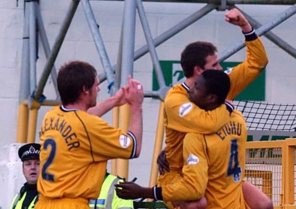 Graham Alexander and David Healy congratulate Dickson Etuhu after he put Preston in front against Swansea City in January 2004