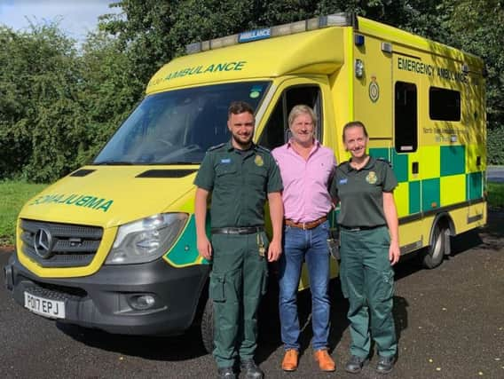 Heart attack survivor Anthony Foster with paramedics Lisa Carne-Ross and Andy Utting