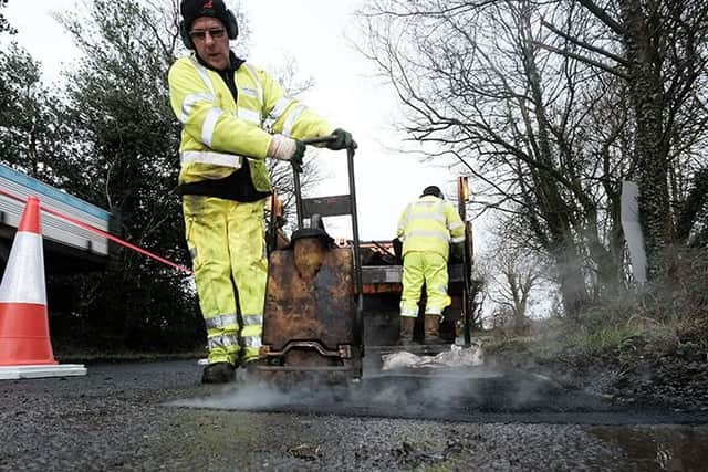 The traditional cut-out-and-fill process of pothole repair is still widely used on routes across the county.