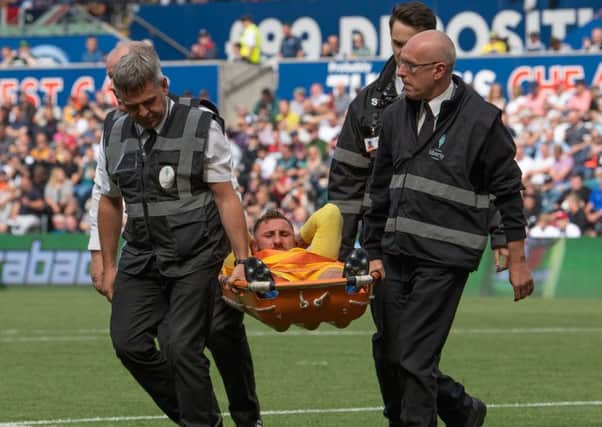 Louis Moult is stretchered off with a knee injury