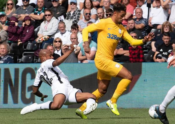 Preston North End's Andre Green (right) is tackled by Swansea City's Andre Ayew (left)