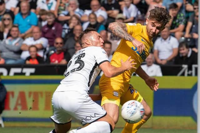 Preston's Sean Maguire battles with Swansea right-back Connor Roberts