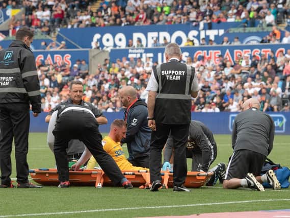 Preston striker Louis Moult is put on a stretcher at Swansea's Liberty Stadium