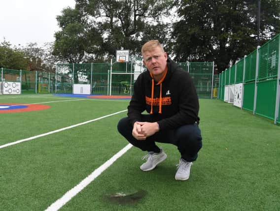 Stewart Boocock standing over burnt artificial pitch on Coronation Rec at the Devonshire Recreation Grounds