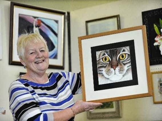 Kathryn Sey with her artwork, Bright Eyes, at one of South Ribble Artists' exhibitions in aid of MacMillan Cancer Trust at Hutton Village Hall.
