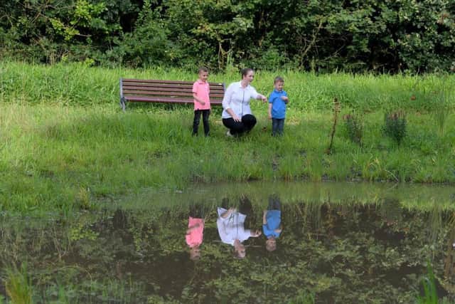 Julie Powell, with her children Albie and Leighton by the pond. (s)