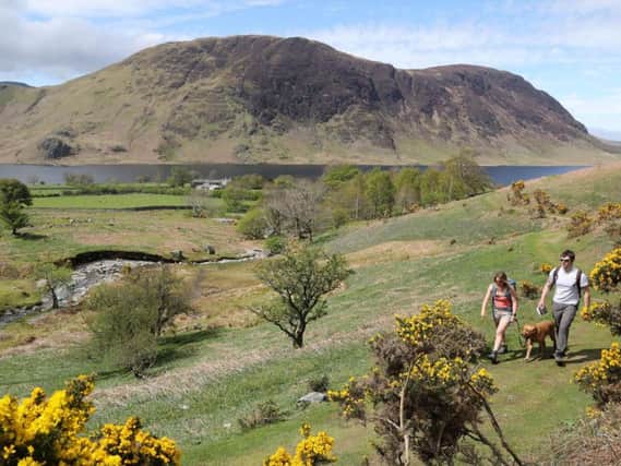Walkers visiting in the Lake District in Cumbria.