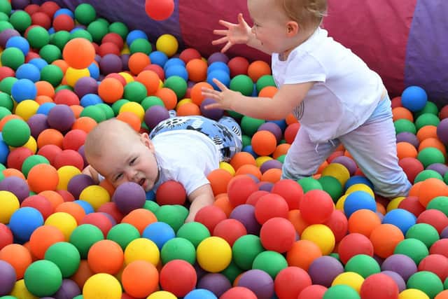 Esme and Henry Palmer play together in the ball pit