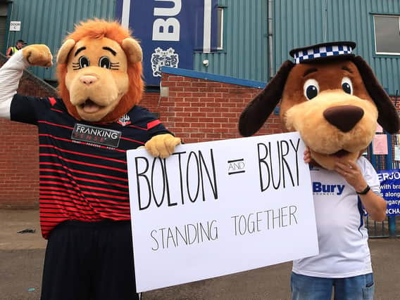 Bolton mascot Lofty the Lion (left) and Bury mascot Robbie the Bobby at Gigg Lane