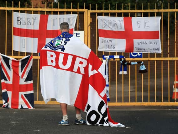 A Bury fan at the gates of Gigg Lane, Bury.