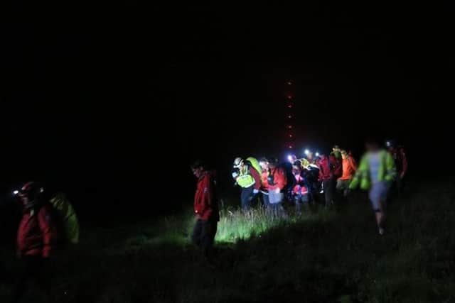 The search party, with the Winter Hill mast in the background (Photo: Bolton Mountain Rescue Team)