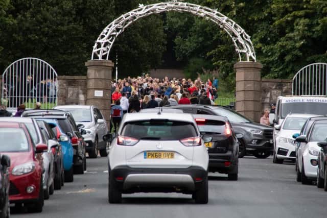 Those joining the tributes gathered at the Avenue Parade entrance of the Coppice.