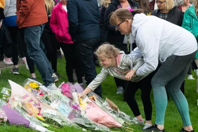 Some of the many flowers laid last night .
