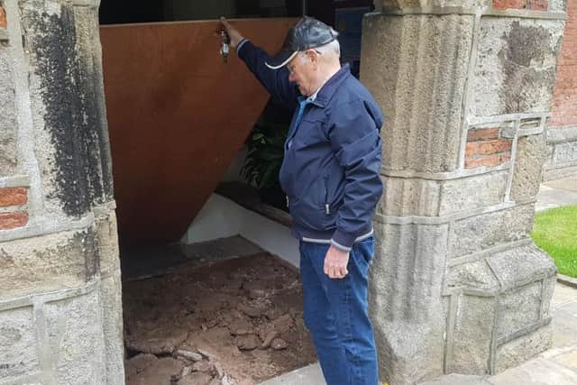 Churchwarden at St Michaels and All Angels Church, Jock Davidson, shows where the stone flags have been ripped up in the church's entrance (Photo: JPIMedia)