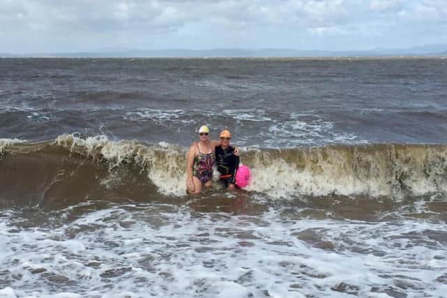 Helen Harvey with her 11-year old son Earnie, who following in his mothers footsteps, in the sea at Morecambe.